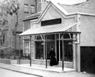 View: c04033 Ellesmere Port: Coulters Shop, Old Mrs Coulter in doorway 	